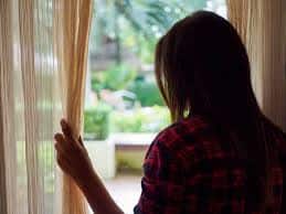 A woman looking outside a window